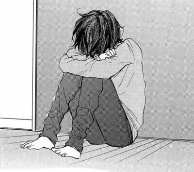 manga boy curled up in a ball sad